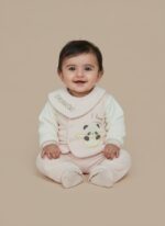 Happy baby wearing a pink Baby Panda Sweater Set with a "Panda" bib, featuring a cute panda design on the sweater.