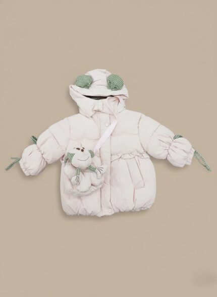 Pink kids puffer jacket with a light pink main color, green and white gingham accents on the hood and cuffs, and a padded frog-shaped crossbody bag attached to the front. The jacket has a hood, full front closure, and a gathered waist.