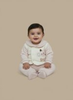 Pink newborn baby sweater set with an elephant design on a cream vest and matching ribbed pants, modeled by a smiling infant.