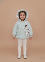 Mint green Baby Girls Quilted Jacket with hood, floral bow, and attached bunny plush toy on a light brown background.