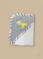 A newborn baby swaddled in a white blanket with green trim, featuring "YOU MAKE ME HAPPY" embroidered text, a teddy bear, an owl, and dinosaur patterns.