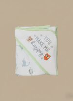 A newborn baby swaddled in a white blanket with green trim, featuring "YOU MAKE ME HAPPY" embroidered text, a teddy bear, an owl, and dinosaur patterns.