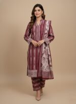 Binsaeed Khaddar Unstitched 3-Piece Suit for women, modeled by a woman, featuring a maroon and white patterned khaddar shirt, printed trousers, and a floral dupatta, ideal for winter.