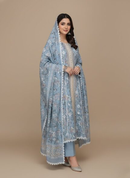 Blue floral printed frock with long sleeves and white lace trim on a plain background.