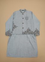 Boy wearing a blue embroidered waistcoat suit with matching kameez shalwar, designed for festive and formal occasions.