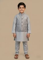 Boys clothes summer set on child: white cotton tee, camo cargo shorts and bucket hat, outdoor playground background