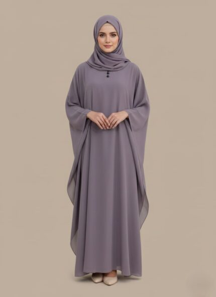 A woman wearing a full-length lavender kaftan abaya with batwing sleeves and a round neckline with small buttons.