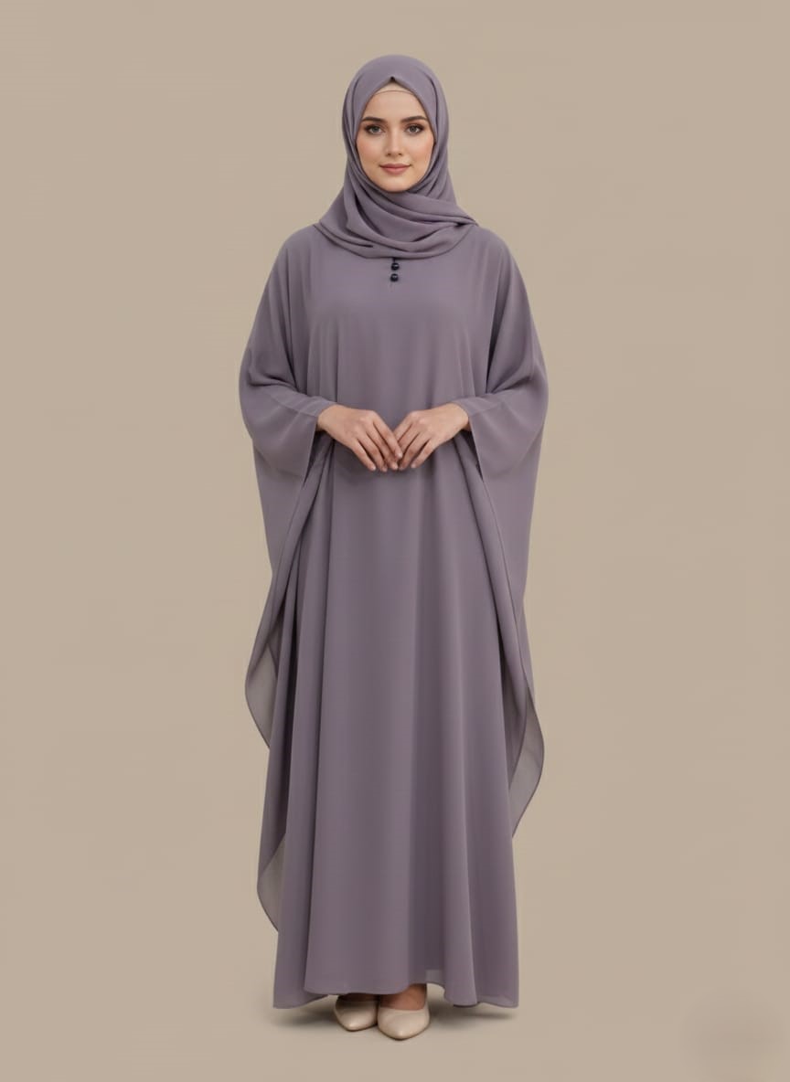 Chic Lavender Kaftan Abaya A woman wearing a full-length lavender kaftan abaya with batwing sleeves and a round neckline with small buttons.