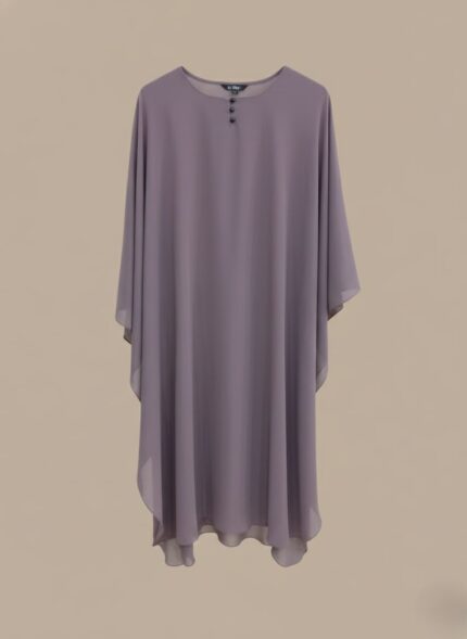 A woman wearing a full-length lavender kaftan abaya with batwing sleeves and a round neckline with small buttons.