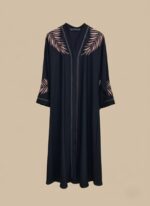 Sand-tone woman abaya in crepe, open-front kimono sweater style, side pockets and belt shown on model in daylight studio