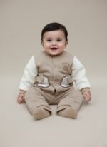 Charming two-piece Baby Quilted Teddy Bear Sweater and Pants Set. Features a cozy quilted beige sweater with cream sleeves, teddy bear embroidery, and matching pants.
