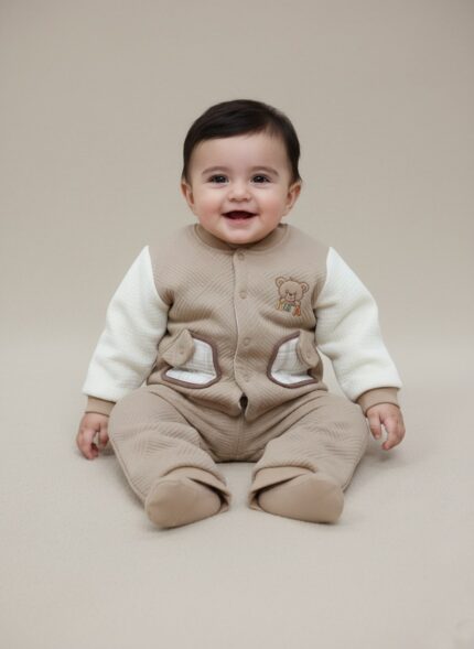 Charming two-piece Baby Quilted Teddy Bear Sweater and Pants Set. Features a cozy quilted beige sweater with cream sleeves, teddy bear embroidery, and matching pants.