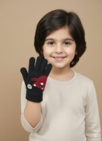 A young child smiling and raising their hand, wearing a black knit glove with a red cartoon bear and "Hi" speech bubble on the back.