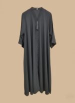 A woman in a full-length black abaya with subtle beading along the V-neck and down the front, accented with a black tassel.