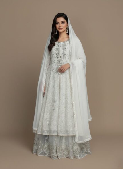 embroidered maxi dress with silver sequins and intricate lace detailing on the hem, accompanied by a matching white dupatta, displayed on a light brown background.