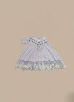 embroidered maxi dress with silver sequins and intricate lace detailing on the hem, accompanied by a matching white dupatta, displayed on a light brown background.