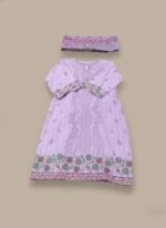 Full-length view of a woman wearing a lavender cotton embroidered suit with a dupatta, standing against a beige background. The suit has intricate floral embroidery on the hem and sleeves.