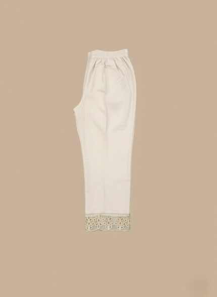 Off-white Women's Embroidered Trouser with intricate floral embroidery on the hem, lying flat against a beige background, highlighting the detail and fabric.