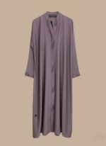 Woman wearing a soft mauve premium abaya with embroidered front design and matching scarf.