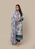 Model in a purple floral printed lawn dress, a three-piece summer collection with green contrasting hem and cuffs, and a matching purple floral patterned dupatta.
