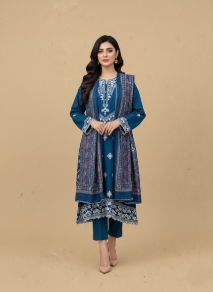 Model in a teal embroidered lawn dress, three-piece summer collection with white embroidery on shirt, patterned dupatta, and trousers.