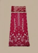 A flat lay showing a maroon embroidered lawn suit with a shirt piece and a folded matching embroidered dupatta. The fabric features intricate white floral and geometric embroidery patterns.