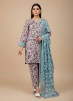 Two folded sets of 3 PC unstitched lawn fabric, one with a prominent pink and teal floral pattern on white, and another smaller teal fabric with white and orange floral motifs, displayed on a wooden table in a retail setting.