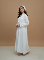 Sand-tone woman abaya in soft crepe, open-front kimono sweater style, side pockets and belt shown on model against neutral backdrop