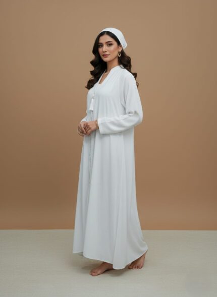 Sand-tone woman abaya in soft crepe, open-front kimono sweater style, side pockets and belt shown on model against neutral backdrop