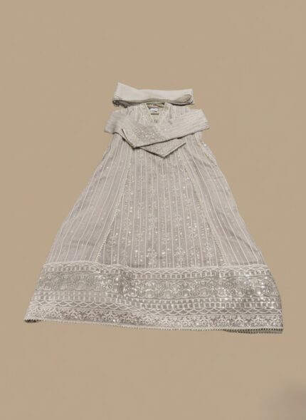 Fuchsia Chikankari maxi dress or Anarkali with silver embroidery and sequin/mirror work, laid flat on a neutral background, showcasing the full length of the long garment.