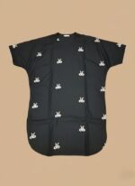 Image of a young girl wearing a black embroidered kids kaftan dress with white patterns.