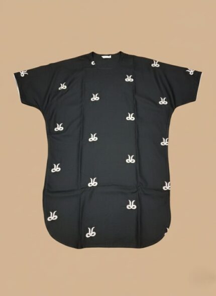 Image of a young girl wearing a black embroidered kids kaftan dress with white patterns.