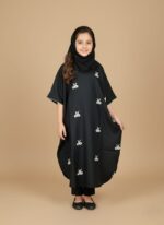 Image of a young girl wearing a black embroidered kids kaftan dress with white patterns.