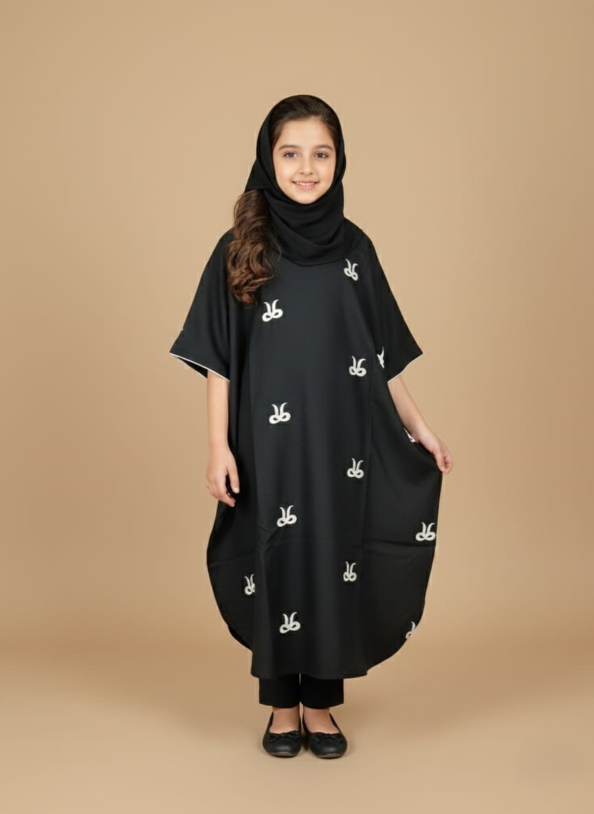 Girls Black Embroidered Kaftan Image of a young girl wearing a black embroidered kids kaftan dress with white patterns.
