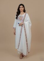 1 piece hand unstitched fabric with circular bohemian pattern and colorful tassels, folded to show a matching embroidered border.