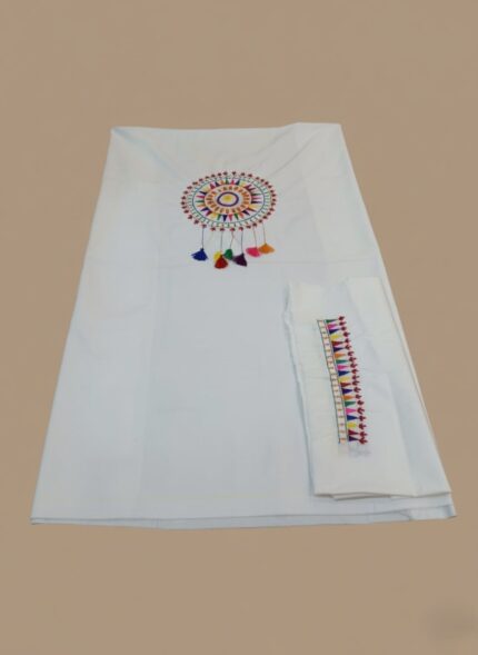 1 piece hand painted unstitched fabric with circular bohemian pattern and colorful tassels, folded to show a matching embroidered border.