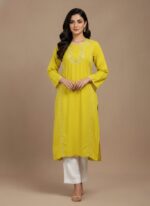 Handmade embroidered yellow tunic dress with traditional stitching on a neutral background.