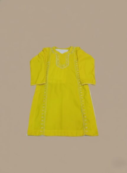 Handmade embroidered yellow tunic dress with traditional stitching on a neutral background.