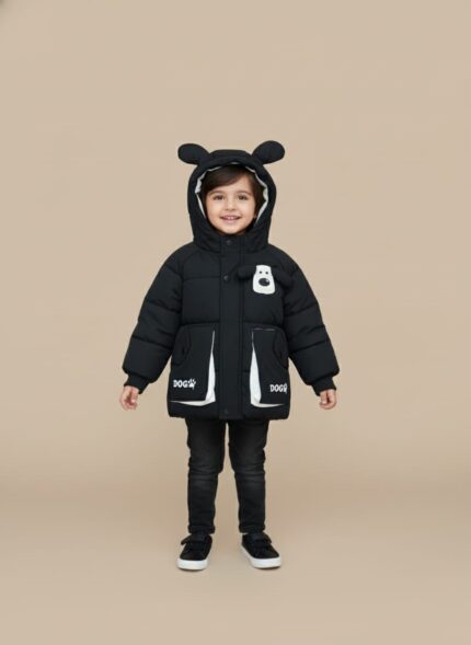 Front view of a young child wearing a black Kids Dog Puffer Jacket with a hood featuring dog ears and a white dog graphic on the chest, along with pockets marked "DOG" with a paw print.