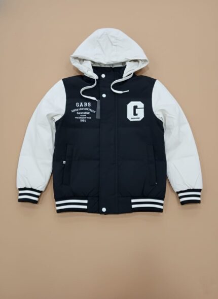 Front view of a black and white Kids Varsity Puffer Jacket with a white hood and sleeves, a black body, and white "GABS" text and a large "G" graphic, worn by a child against a plain background.