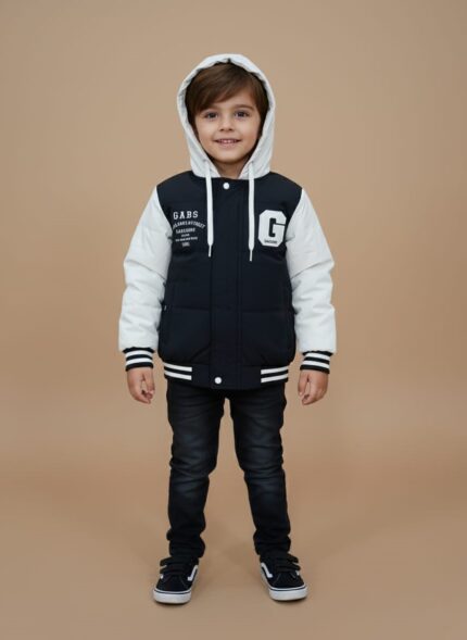 Front view of a black and white Kids Varsity Puffer Jacket with a white hood and sleeves, a black body, and white "GABS" text and a large "G" graphic, worn by a child against a plain background.