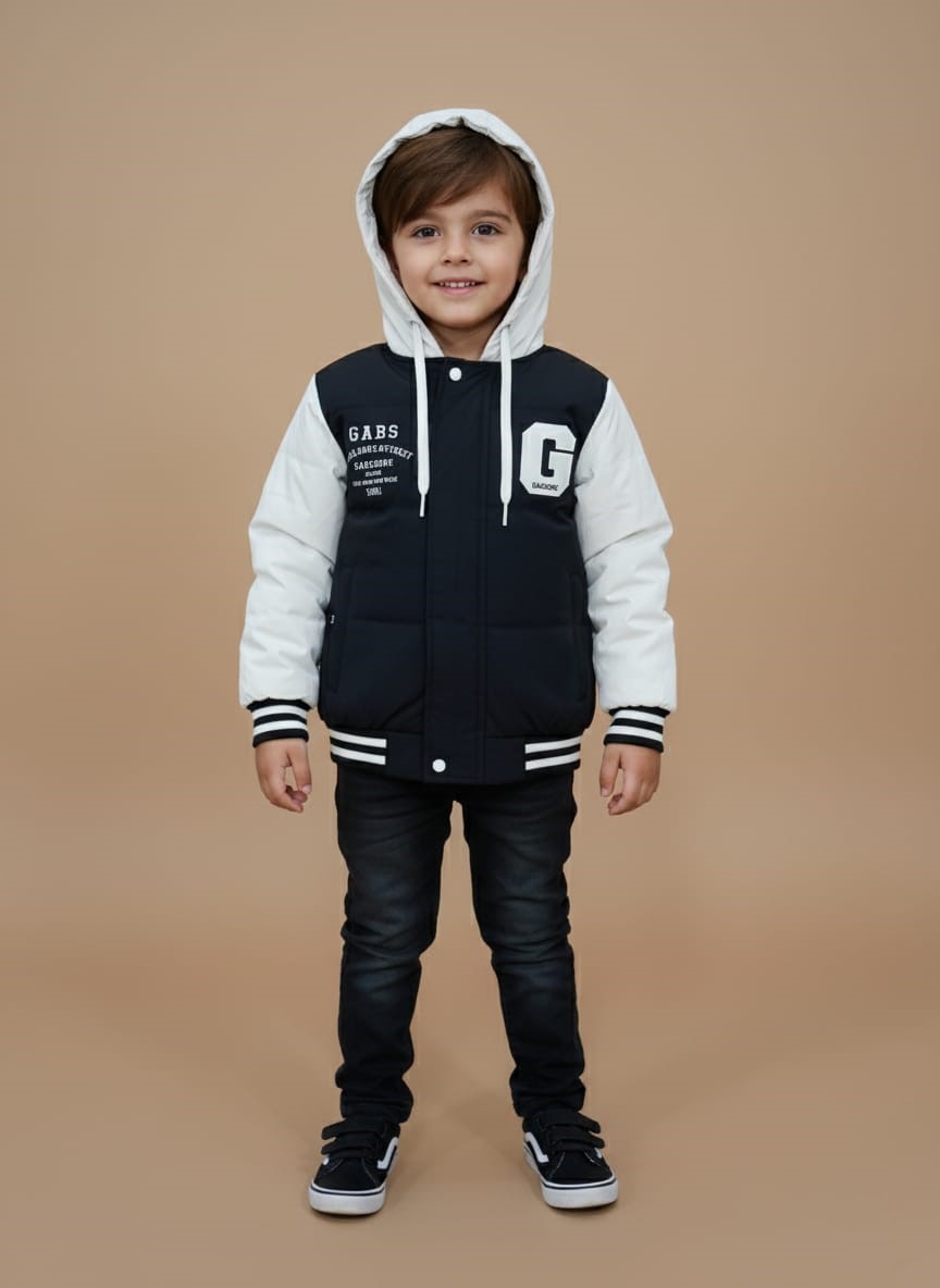 Kids Varsity Puffer Jacket Front view of a black and white Kids Varsity Puffer Jacket with a white hood and sleeves, a black body, and white "GABS" text and a large "G" graphic, worn by a child against a plain background.