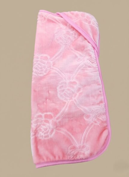 Pink baby blanket with hood, ultra-soft coral fleece with embossed rose pattern and pink trim, folded neatly on a neutral background, for baby girls.
