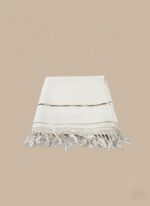Folded white men's shawl with fringes and subtle stripe detail