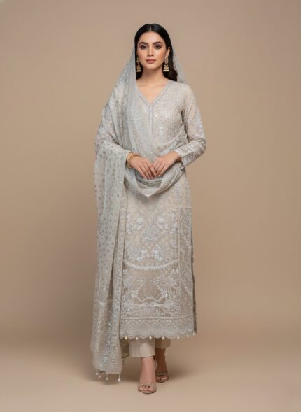 Flat lay of an ivory/light beige Embroidered Chiffon Dress material. Includes a heavily embroidered and embellished chiffon shirt piece, a stone work dupatta, dyed printed rawsilk trouser, and raw silk inner fabric pieces. Ideal for formal Pakistani/Indian attire.