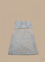 Flat lay of an ivory/light beige Embroidered Chiffon Dress material. Includes a heavily embroidered and embellished chiffon shirt piece, a stone work dupatta, dyed printed rawsilk trouser, and raw silk inner fabric pieces. Ideal for formal Pakistani/Indian attire.