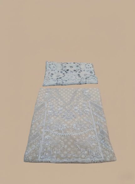Flat lay of an ivory/light beige Embroidered Chiffon Dress material. Includes a heavily embroidered and embellished chiffon shirt piece, a stone work dupatta, dyed printed rawsilk trouser, and raw silk inner fabric pieces. Ideal for formal Pakistani/Indian attire.