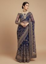 Unstitched 3-piece navy blue embroidered net dress suit set. The fabric features intricate white traditional embroidery on the bottom edge and an ornate embroidered net front. A folded geometric patterned embroidered net dupatta is placed above the shirt fabric.