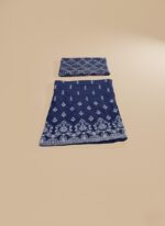 Unstitched 3-piece navy blue embroidered net dress suit set. The fabric features intricate white traditional embroidery on the bottom edge and an ornate embroidered net front. A folded geometric patterned embroidered net dupatta is placed above the shirt fabric.