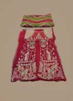 Close-up of a red hand embellished net bridal outfit with heavy silver and gold embroidery, paired with a vibrant green and red striped organza dupatta. Includes embroidered bodice, panels on net, cotton inner, and raw silk trouser.